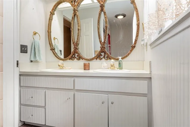 a bathroom with a sink vanity and a mirror