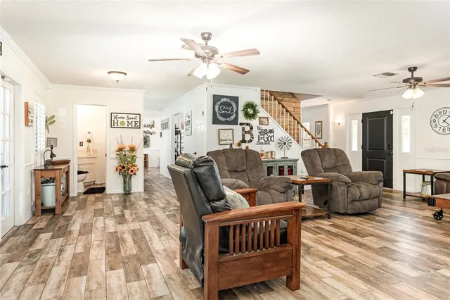 a living room with furniture and wooden floor