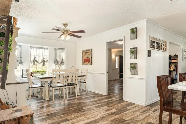 a view of a dining room with furniture and chandelier