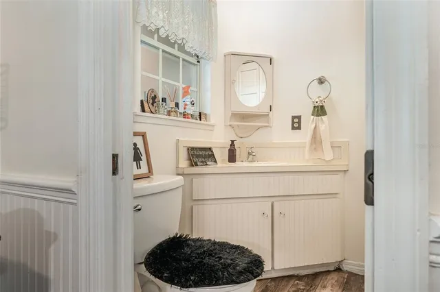 a bathroom with a sink a toilet and a mirror