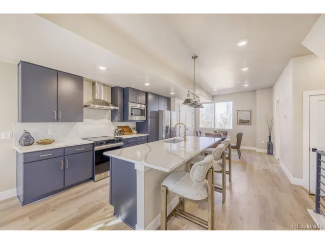 a kitchen with stainless steel appliances kitchen island granite countertop a sink and cabinets