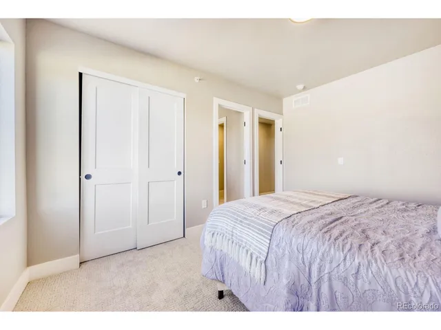 a bedroom with a bed and a painting