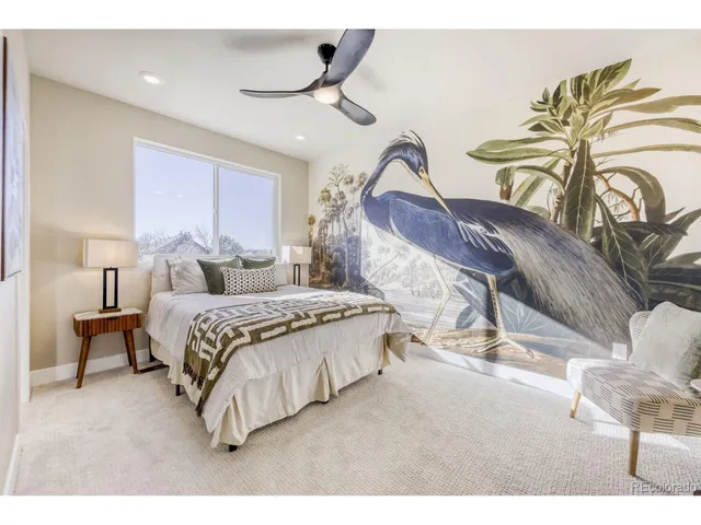 a living room with a bed furniture and a potted plant