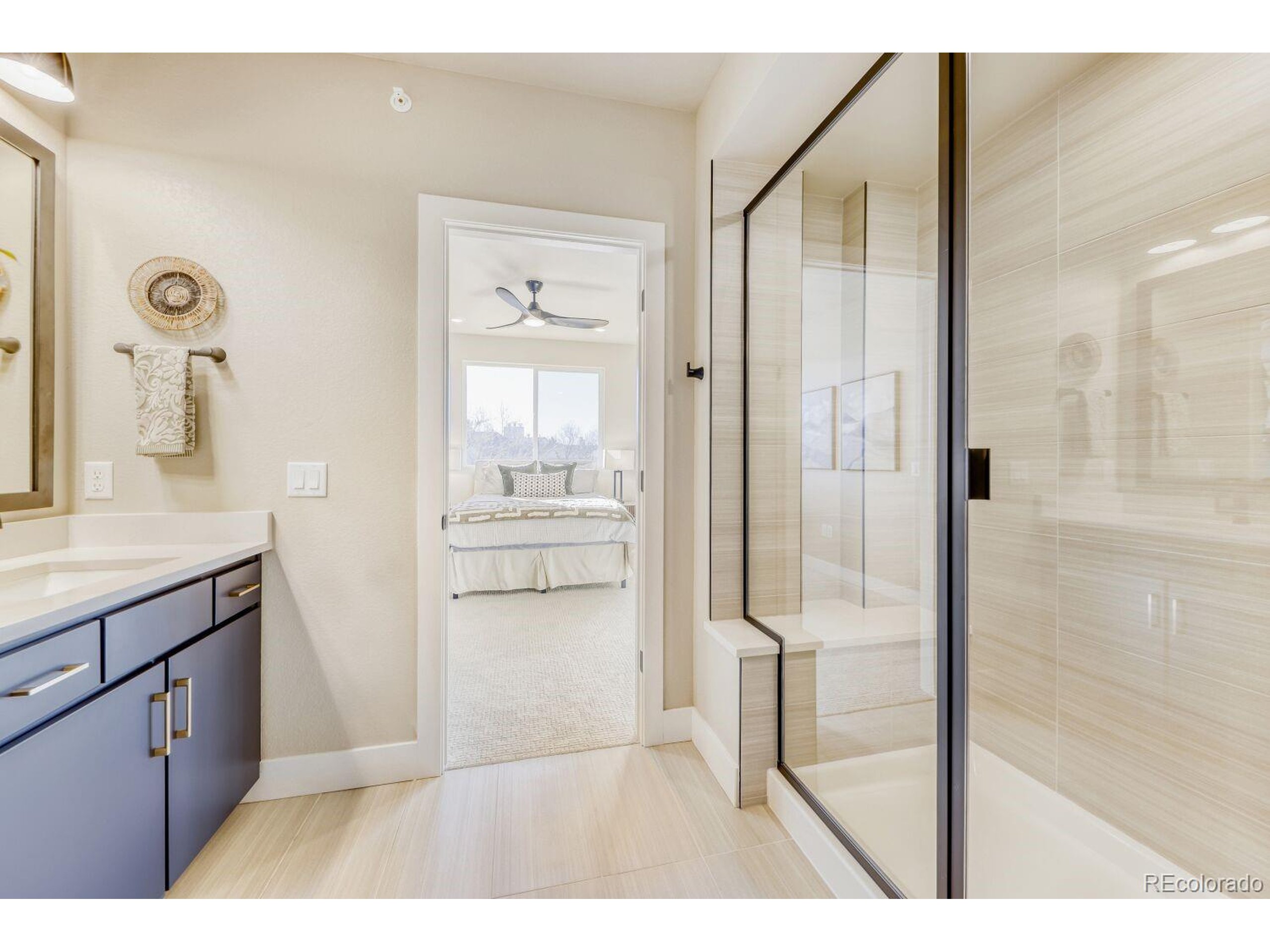 9195 Pierce Street, Unit 1 Westminster, CO 80021 - Photo 23 of 25 a bathroom with a tub shower vanity and sink