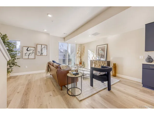 a living room with furniture a dining table and a wooden floor