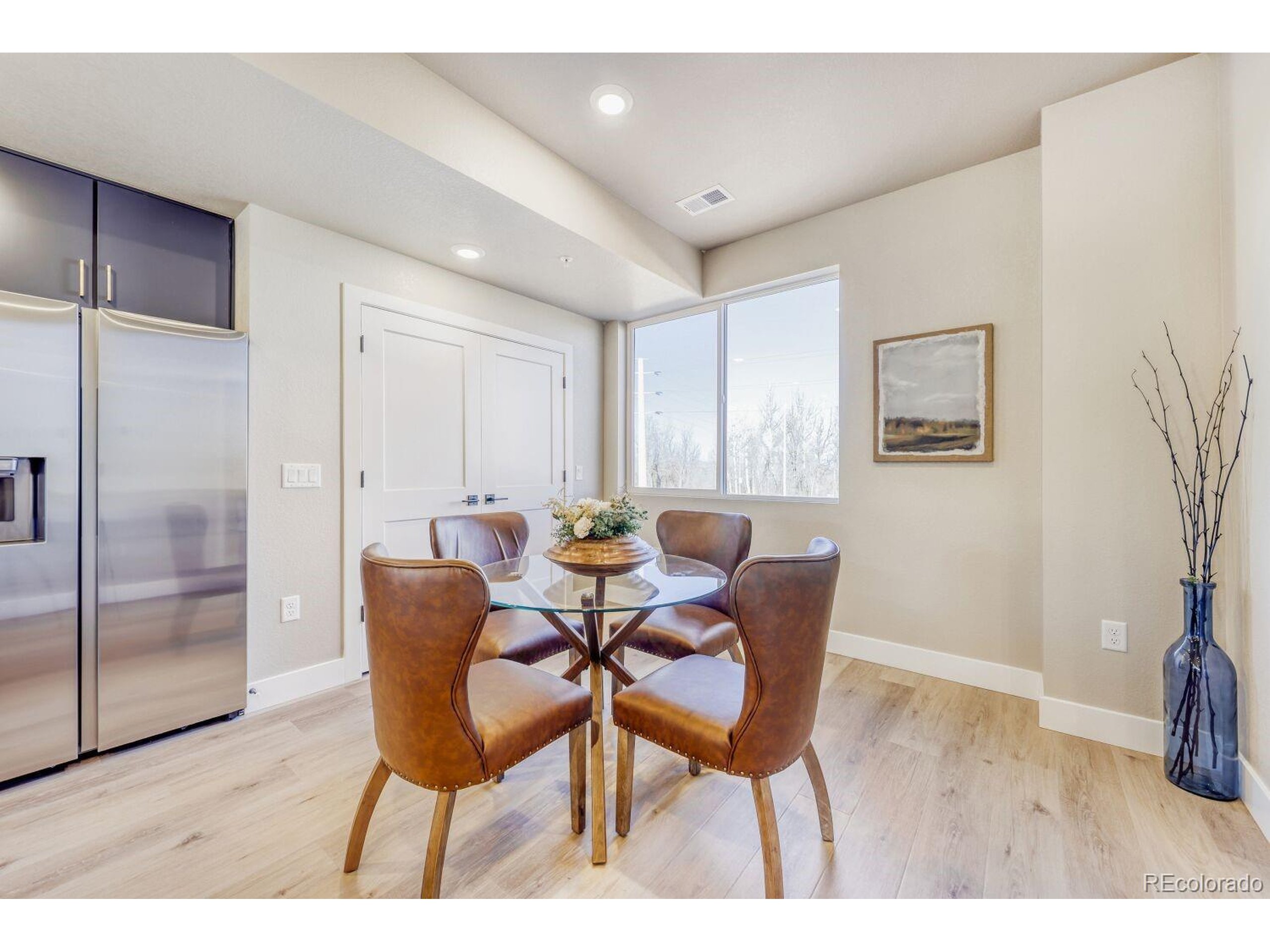 9195 Pierce Street, Unit 1 Westminster, CO 80021 - Photo 6 of 25 a dining room with furniture and wooden floor