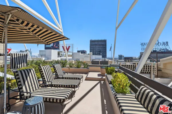 a balcony with furniture and a potted plant