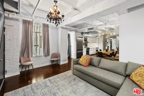 a living room with furniture and a chandelier