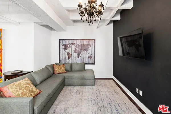 a living room with furniture and a chandelier