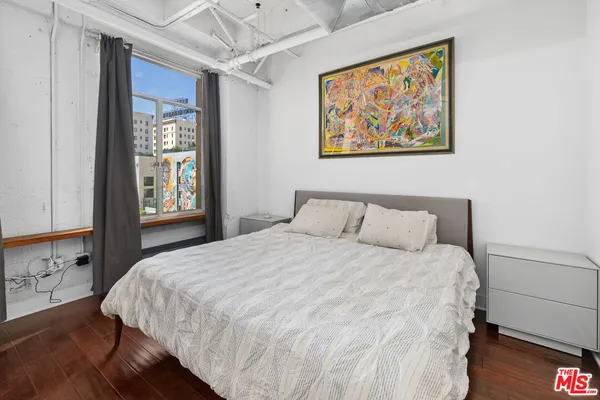 a bedroom with a large bed and a window