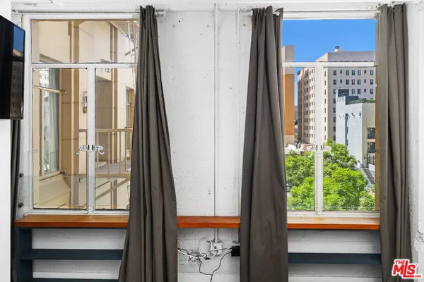 a view of a balcony with a floor to ceiling window