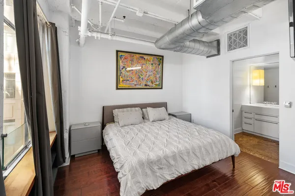 a bedroom with a bed and a view of bathroom