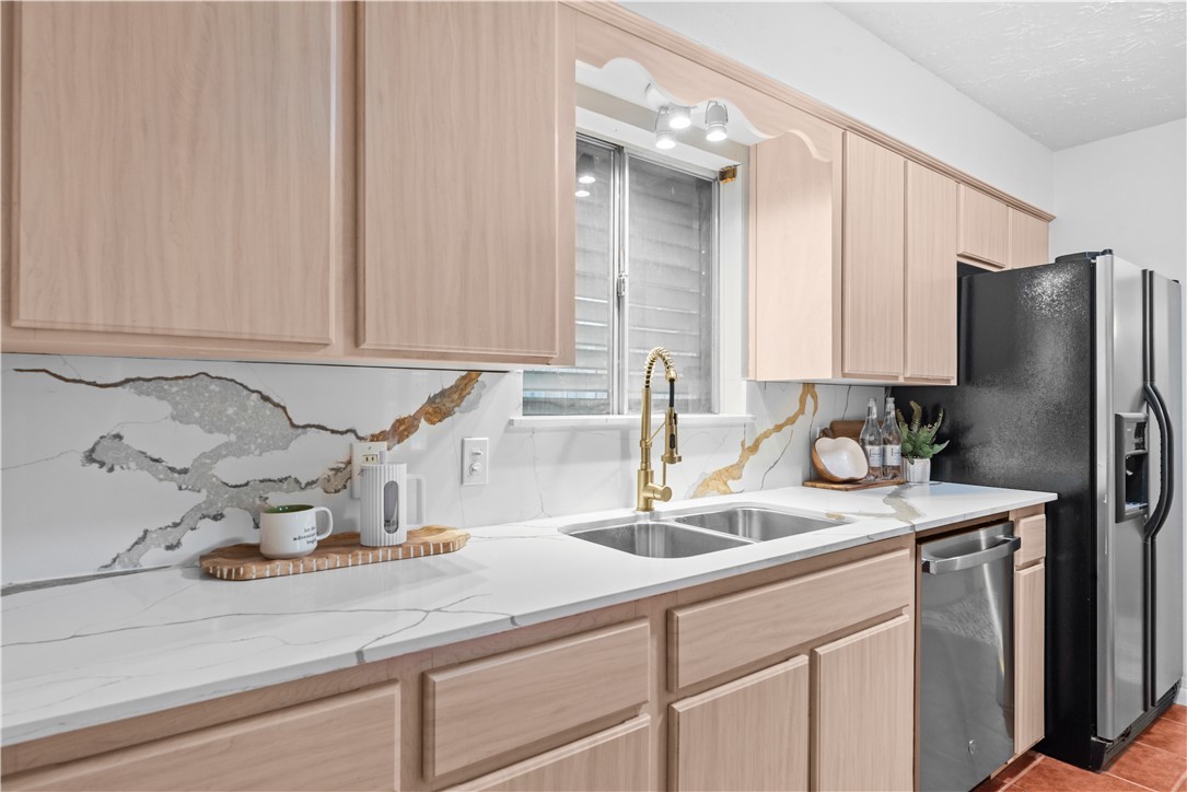 225 Pecos Drive Portland, TX 78374 - Photo 4 of 17 a kitchen with a sink and cabinets