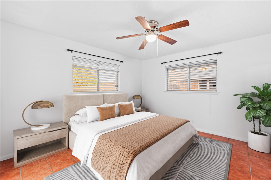 225 Pecos Drive Portland, TX 78374 - Photo 6 of 17 a bedroom with a bed and a chandelier