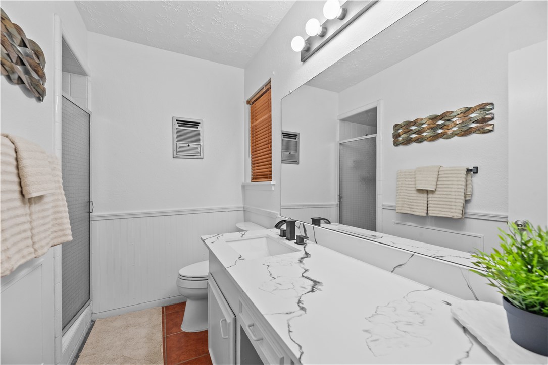 225 Pecos Drive Portland, TX 78374 - Photo 7 of 17 a bathroom with a sink a mirror and a shower