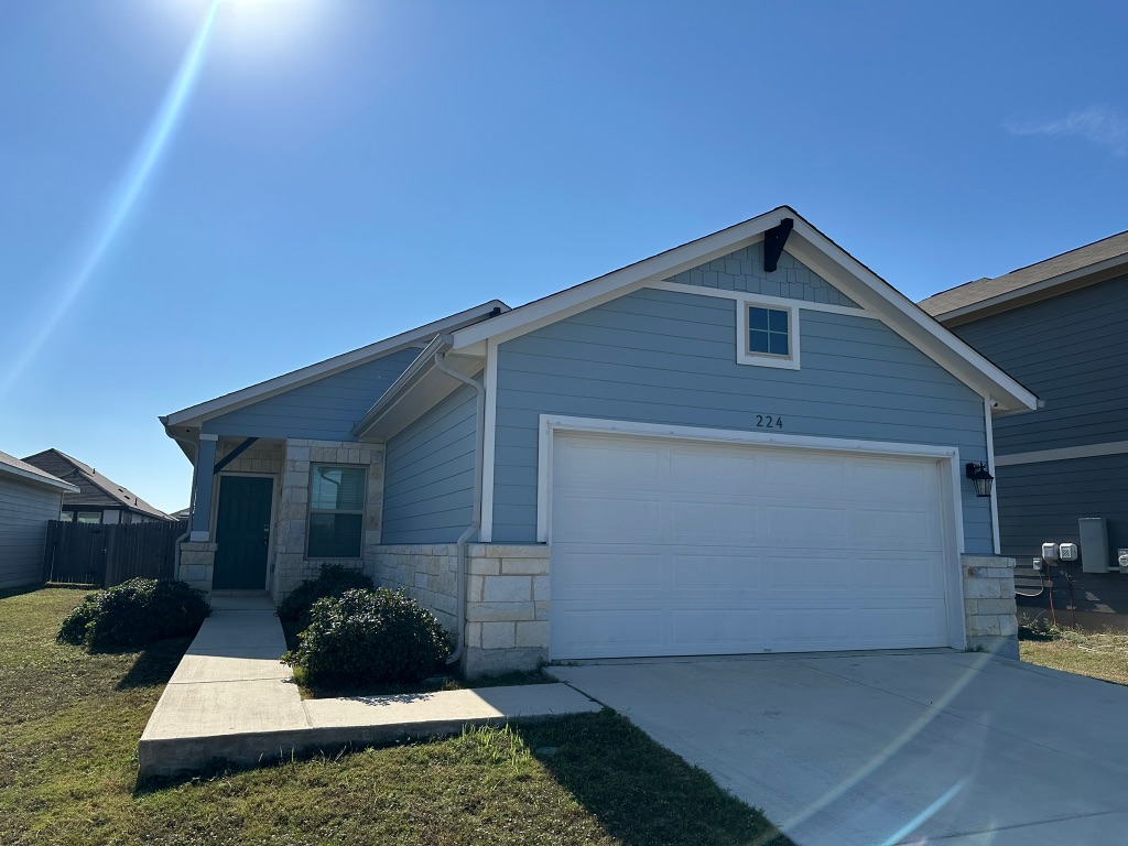 224 Wild Wind Trail Jarrell, TX 76537 - Photo 1 of 13 a front view of a house with a yard