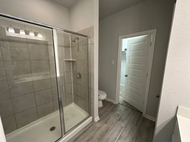 a bathroom with a sink toilet and shower