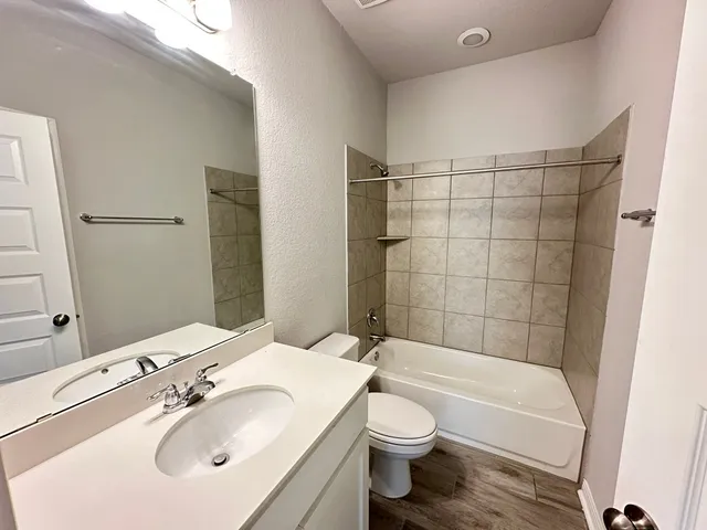 an empty room with closet and a ceiling fan