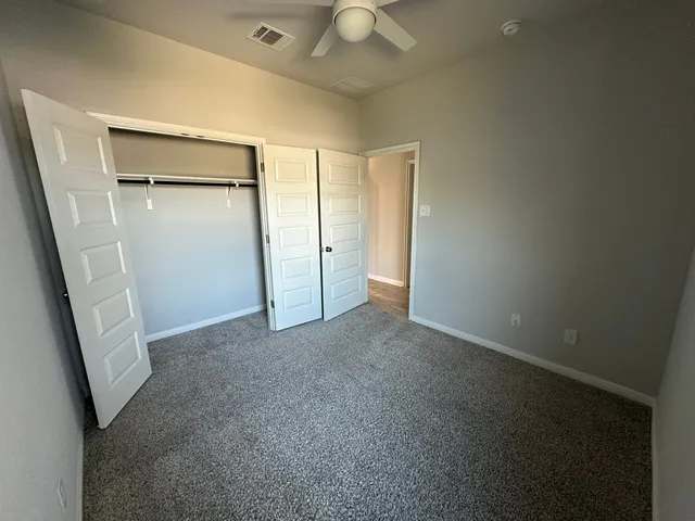 a view of empty room with closet and cabinet