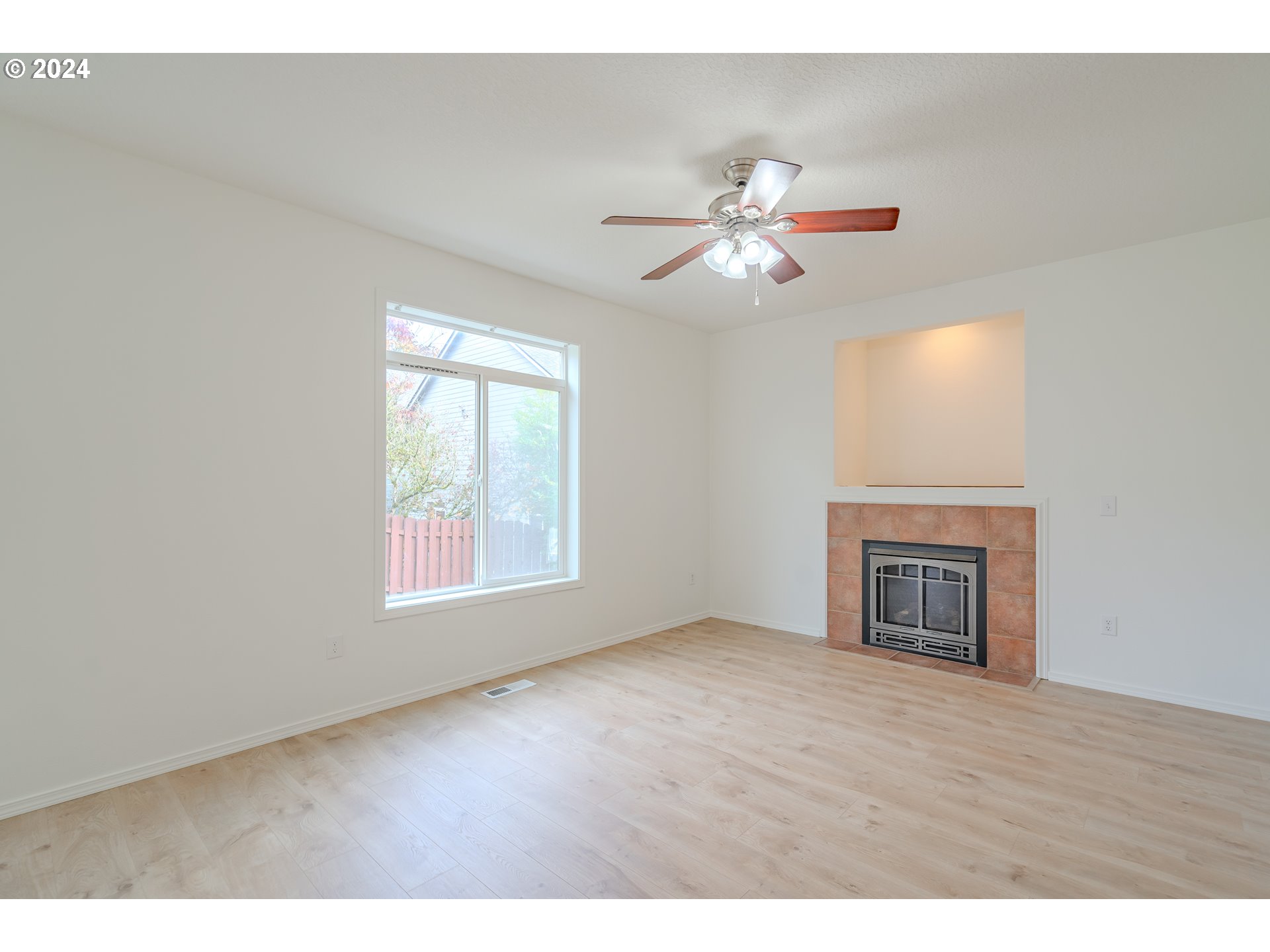 314 South 34th Place Ridgefield, WA 98642 - Photo 14 of 48 a view of an empty room with chandelier fan and wooden floor