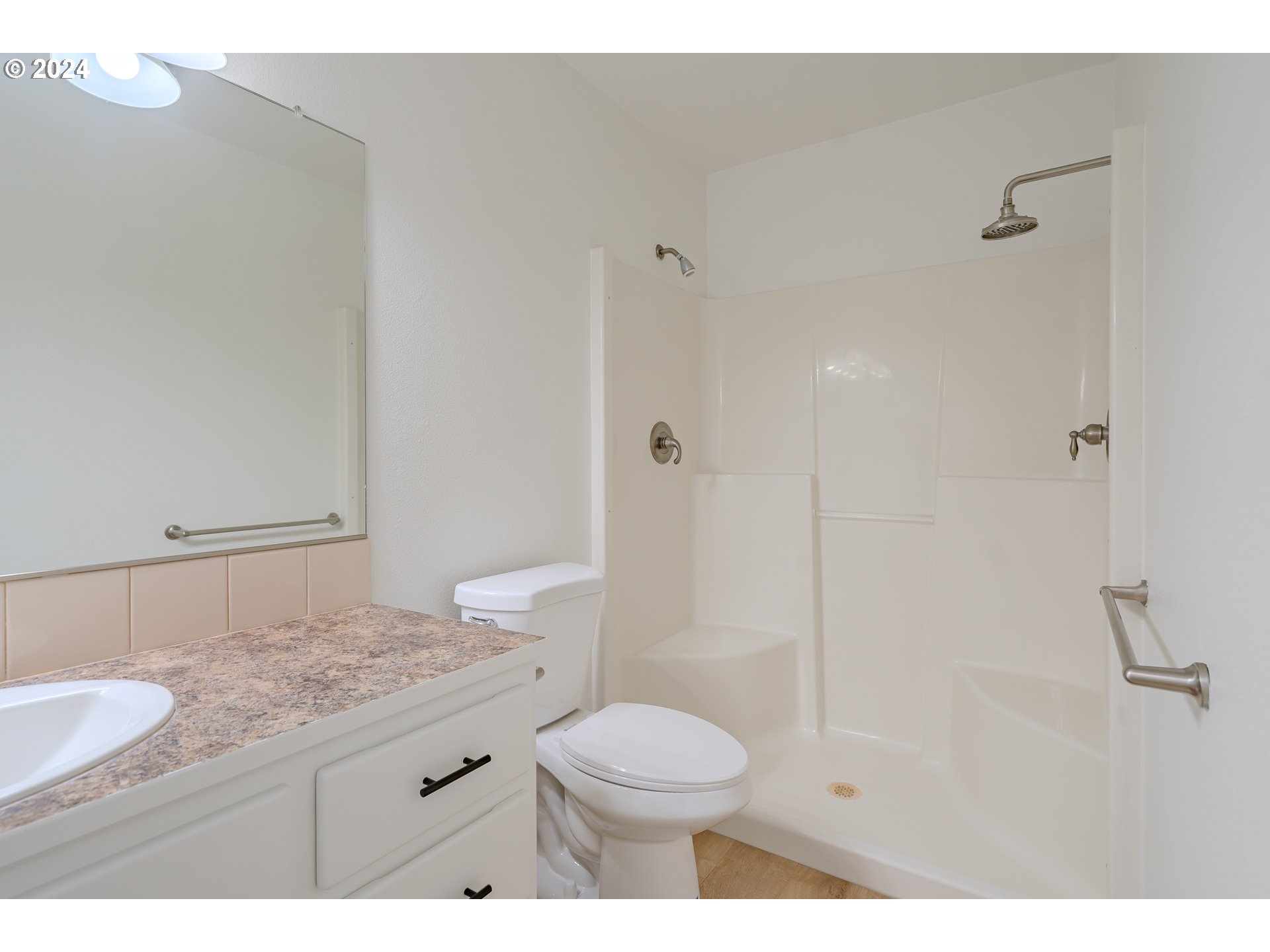 314 South 34th Place Ridgefield, WA 98642 - Photo 27 of 48 a bathroom with a granite countertop sink a toilet a mirror and shower