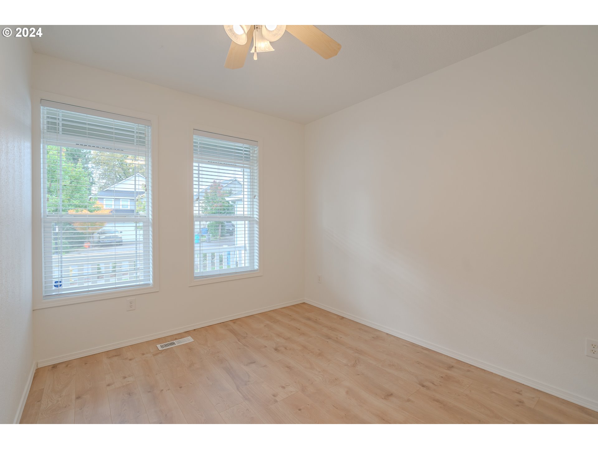 314 South 34th Place Ridgefield, WA 98642 - Photo 3 of 48 a view of an empty room with wooden floor and a window