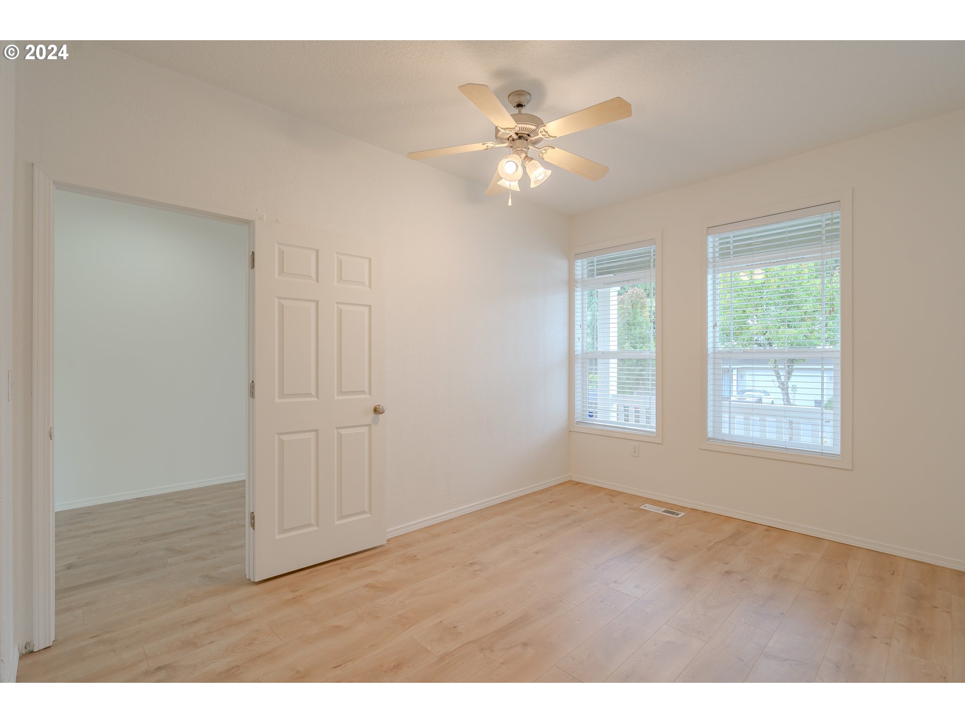 314 South 34th Place Ridgefield, WA 98642 - Photo 4 of 48 a view of an empty room with wooden floor and a window