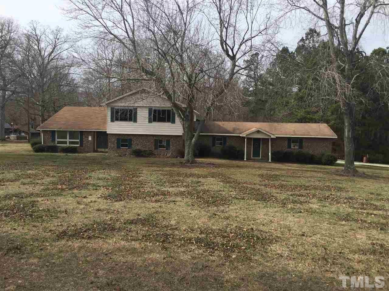 1806 Whitt Town Road Roxboro, NC 27574 - Photo 1 of 11 a front view of a house with garden