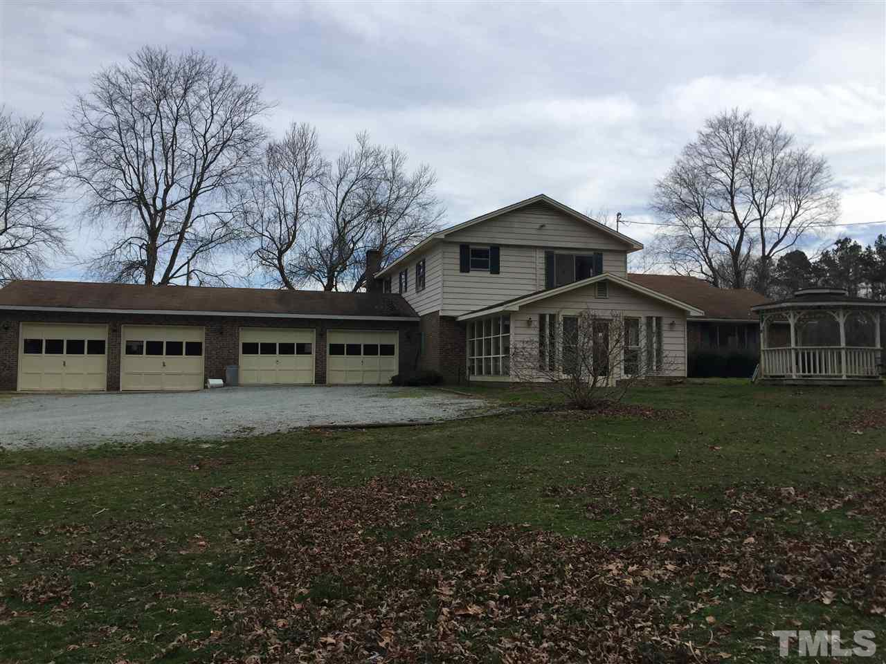 1806 Whitt Town Road Roxboro, NC 27574 - Photo 2 of 11 a front view of a house with a garden