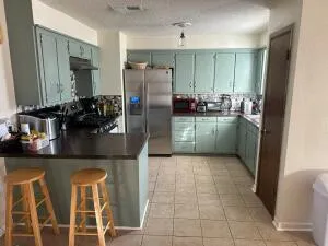a kitchen with granite countertop a refrigerator and a sink