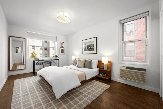 a bathroom with a sink toilet double vanity and tub