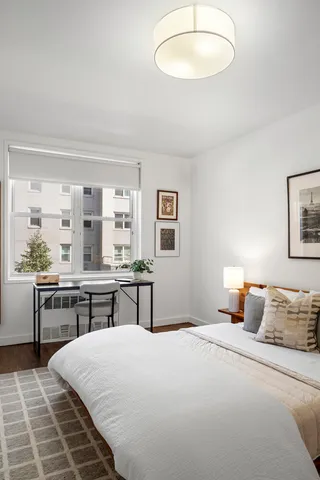 a bedroom with a large bed and a window