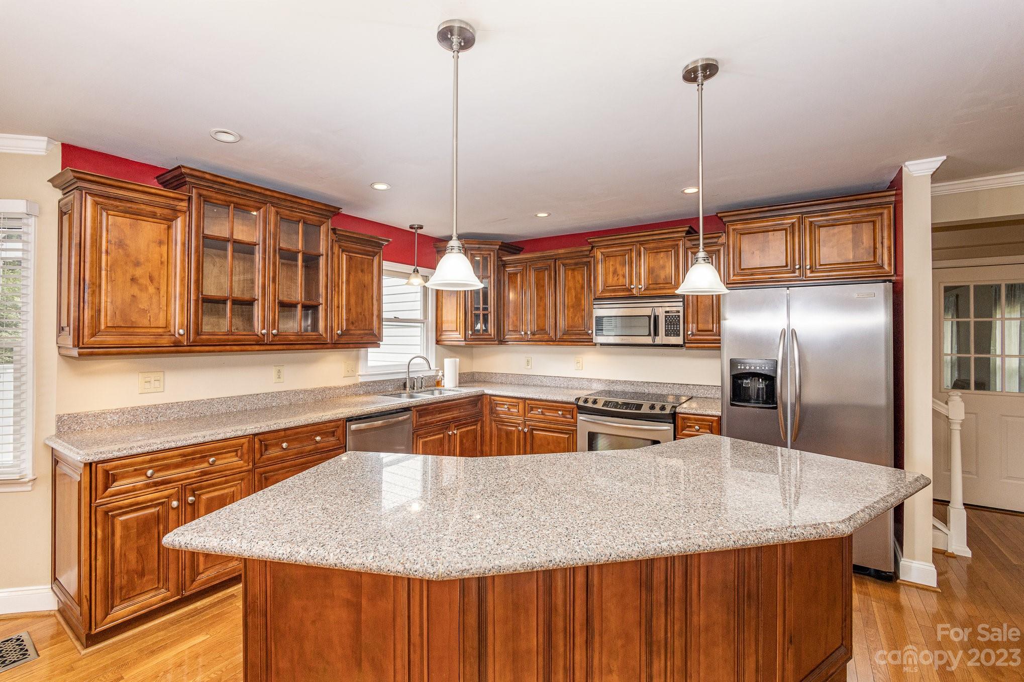 15531 Stumptown Road Huntersville, NC 28078 - Photo 11 of 35 a kitchen with stainless steel appliances granite countertop a sink a counter space and cabinets