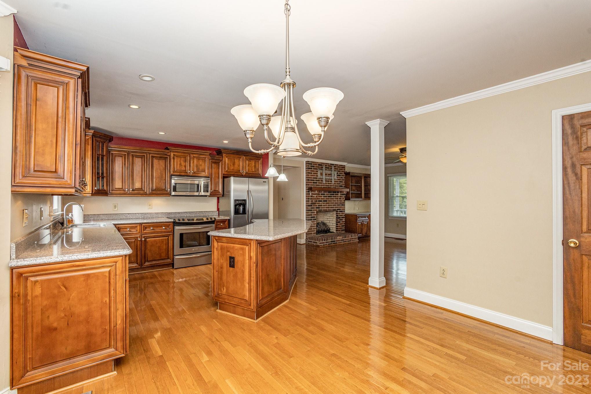 15531 Stumptown Road Huntersville, NC 28078 - Photo 14 of 35 a kitchen with stainless steel appliances granite countertop a sink a stove top oven a counter space and cabinets
