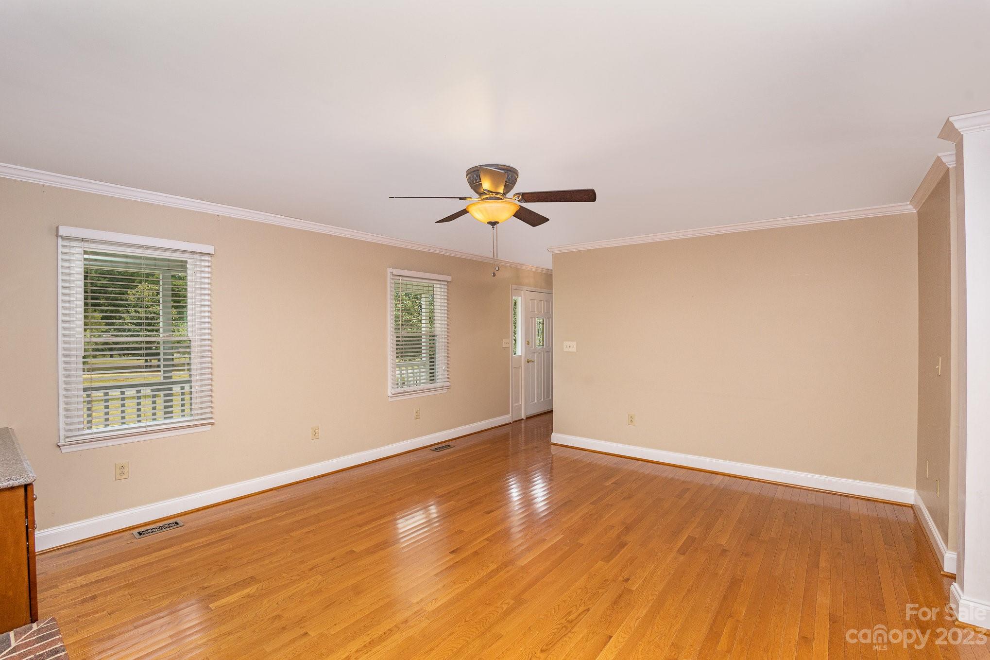 15531 Stumptown Road Huntersville, NC 28078 - Photo 19 of 35 a view of an empty room with wooden floor and a window