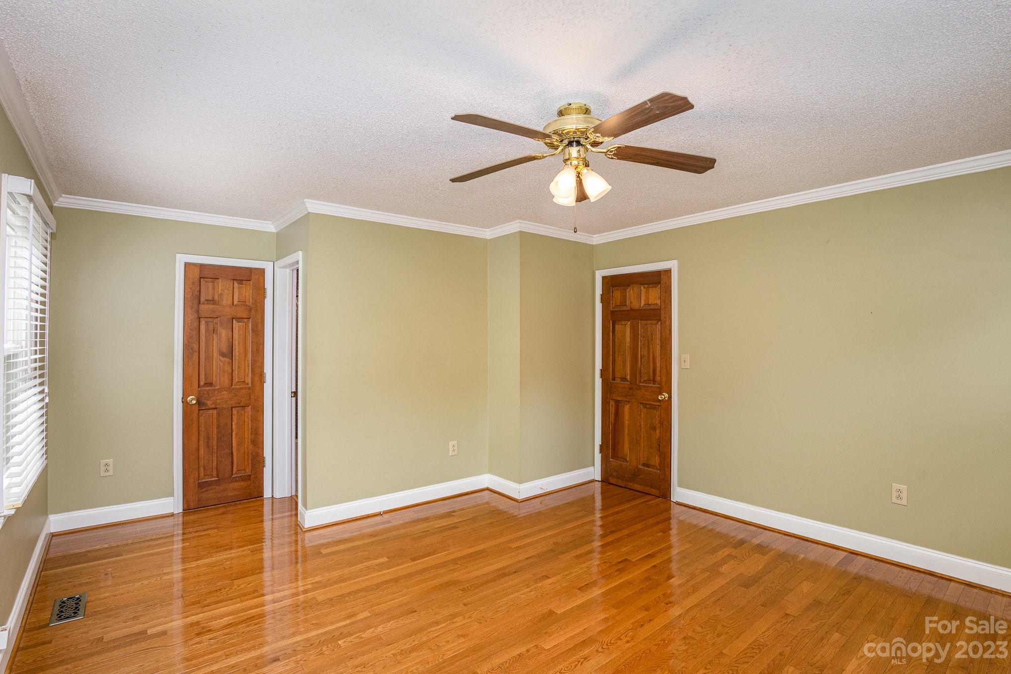 15531 Stumptown Road Huntersville, NC 28078 - Photo 23 of 35 a view of an empty room with wooden floor and a window
