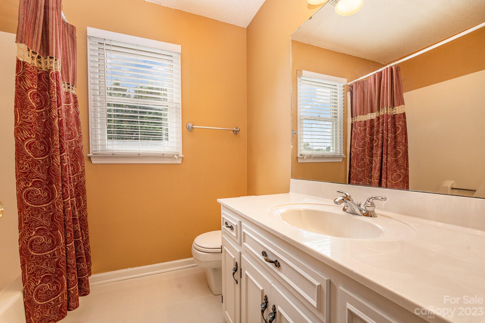 15531 Stumptown Road Huntersville, NC 28078 - Photo 27 of 35 a bathroom with a granite countertop sink toilet and shower
