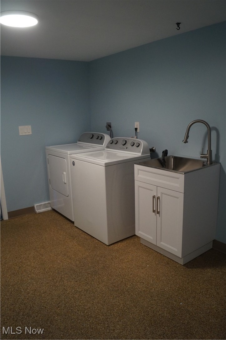 7372 Liberty Road Solon, OH 44139 - Photo 9 of 33 Utility sink with cabinet space and washer and dryer with closet and nature stone flooring - entrance off of garage