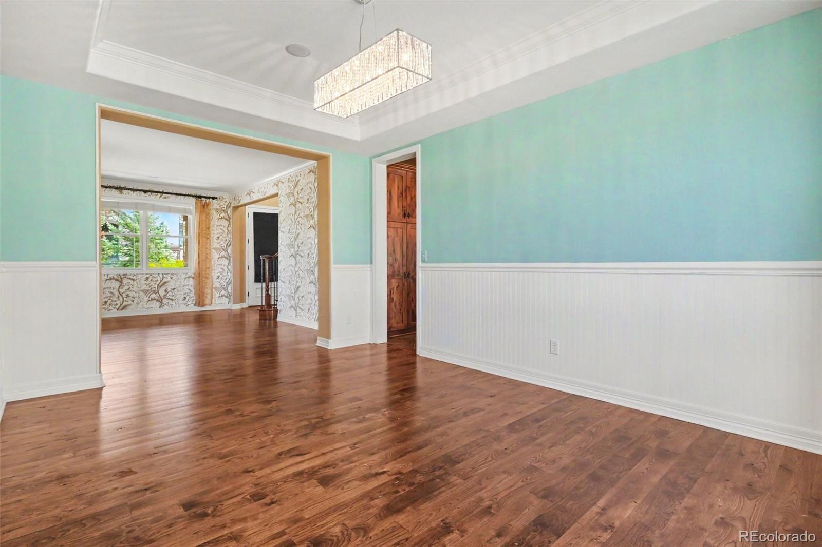 791 Elk Rest Road Evergreen, CO 80439 - Photo 8 of 46 a view of an empty room with wooden floor and a window