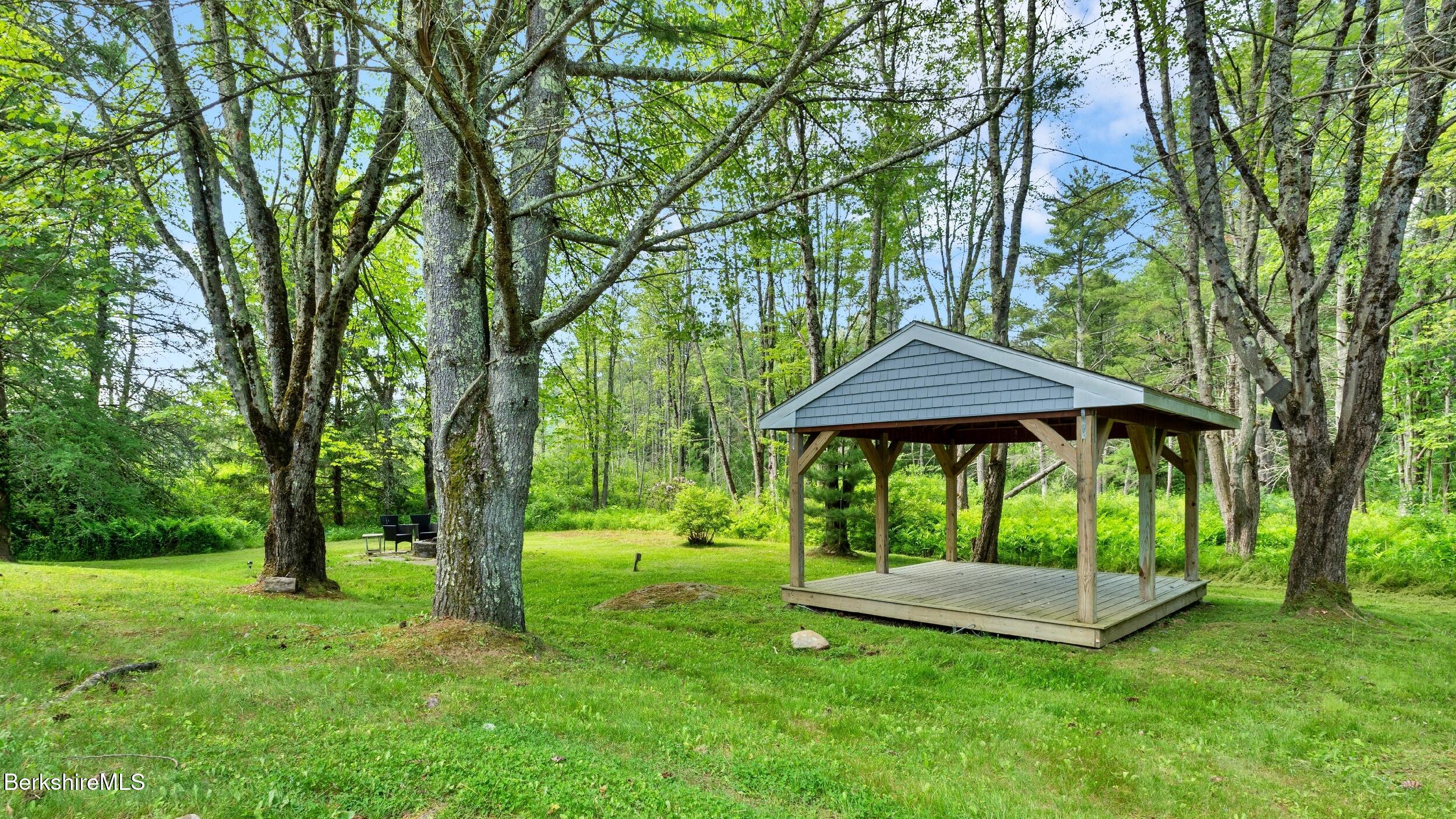 418 Monterey Road Great Barrington, MA 01230 - Photo 25 of 28 a view of a table and chairs under an umbrella