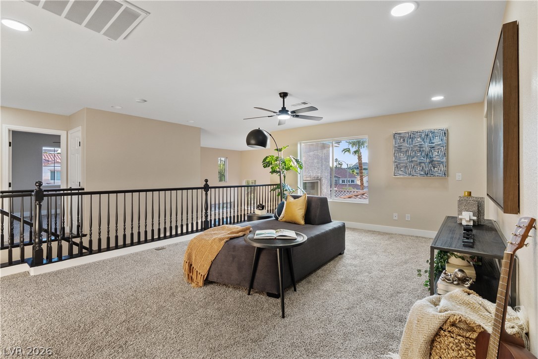 1662 Ravanusa Drive Henderson, NV 89052 - Photo 38 of 74 A versatile open loft space offers comfortable leisure alongside a window revealing distant neighborhood views.