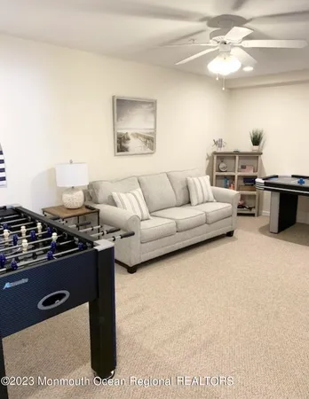 a living room with furniture a chandelier and a stove