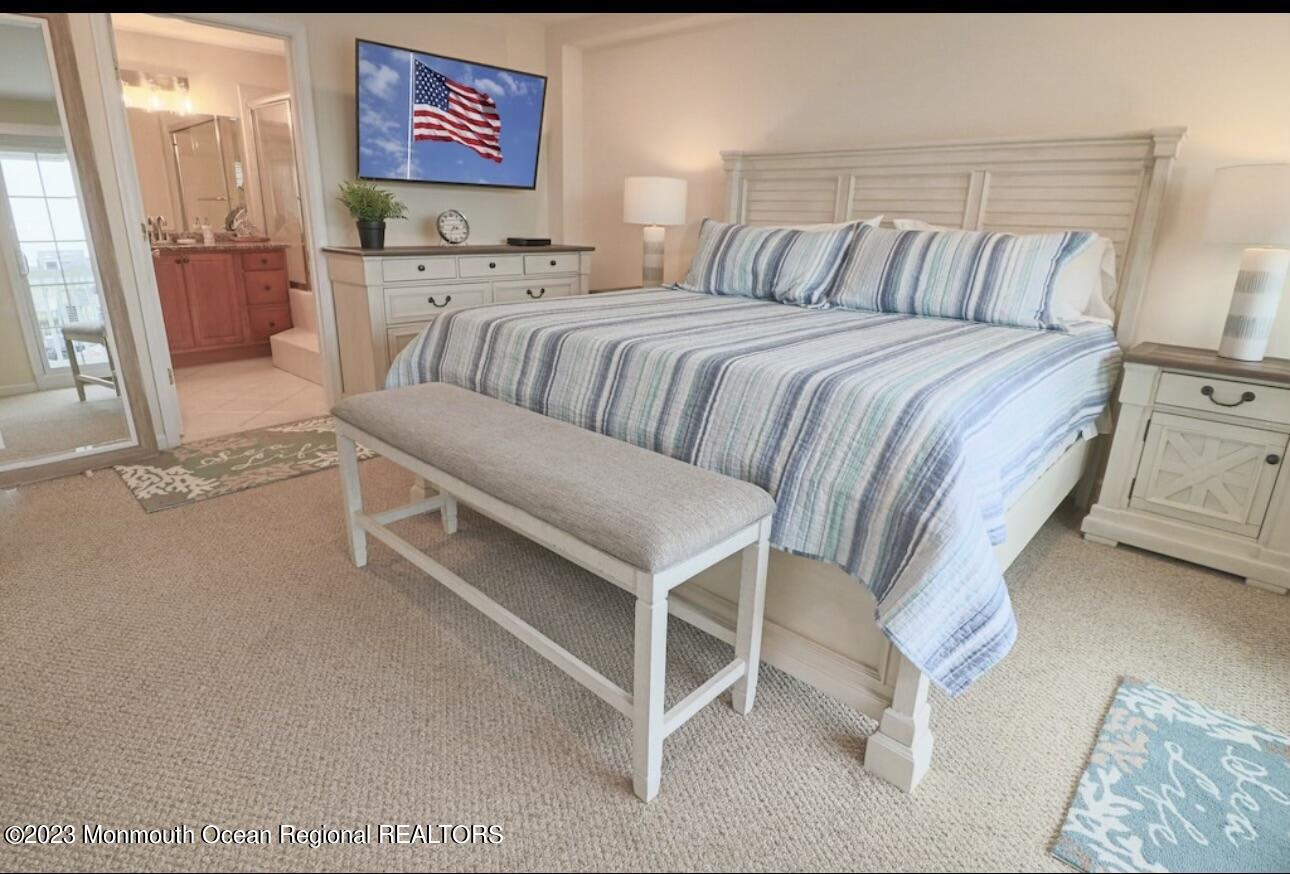 1301 Ocean Boulevard, Unit 10 Seaside Heights, NJ 08751 - Photo 7 of 13 a bedroom with a bed and a couch