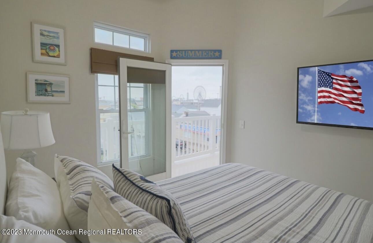 1301 Ocean Boulevard, Unit 10 Seaside Heights, NJ 08751 - Photo 9 of 13 a bedroom with a bed and a painting on the wall