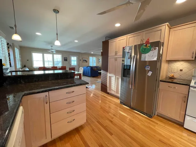 a kitchen with granite countertop a refrigerator and a sink