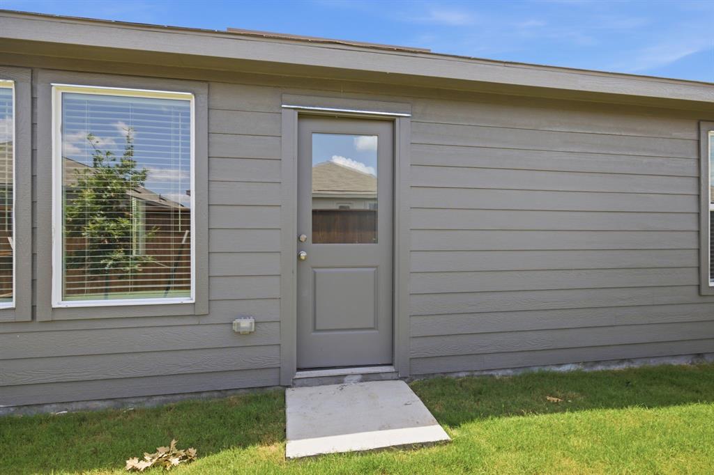 2128 Doc Holliday Road Joshua, TX 76058 - Photo 27 of 28 Exterior featuring horizontal siding, multiple windows, and a glass-paneled entry door