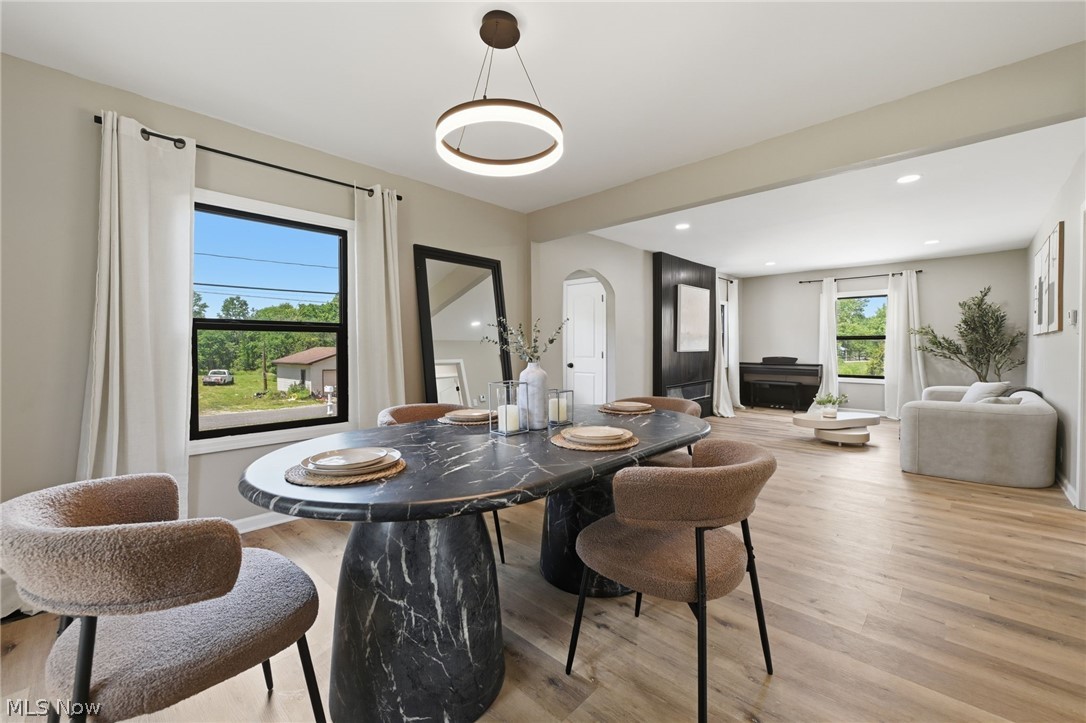 951 Bey Road Akron, OH 44312 - Photo 11 of 34 Dining area featuring a dark marble-look pedestal table and a contemporary circular pendant light