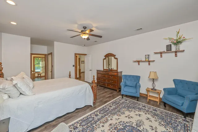 a bedroom with a bed a couch and a dresser