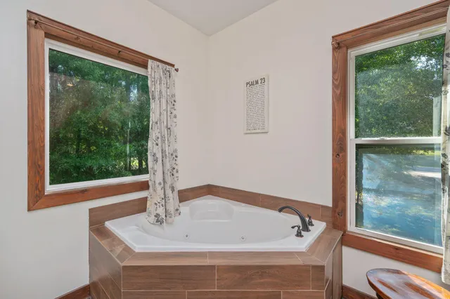 a bath tub sitting in a bathroom next to a window