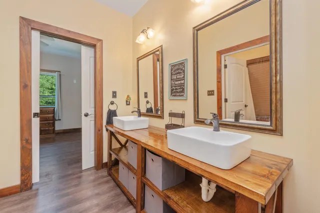 a spacious bathroom with a double vanity sink and a mirror